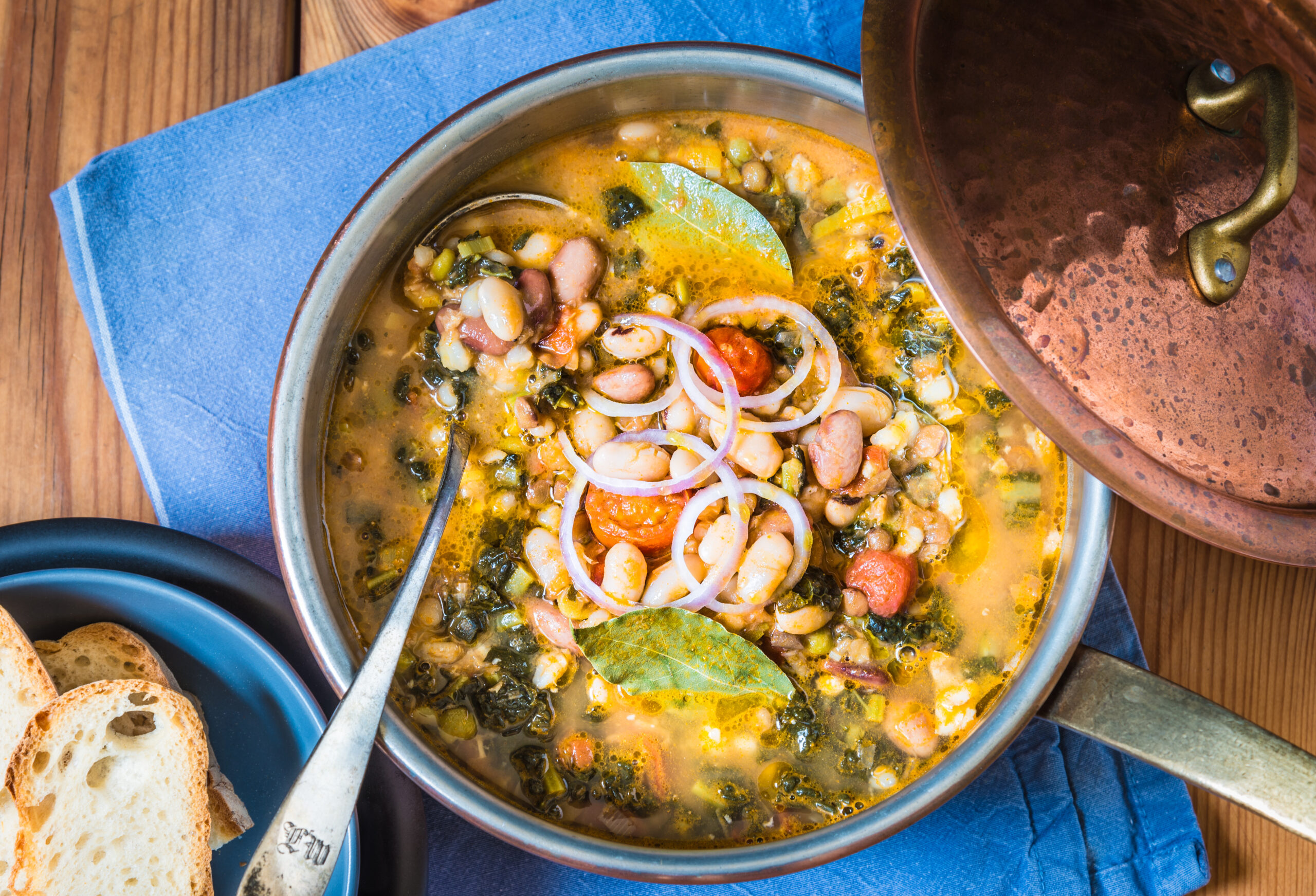 Bowl of traditional tuscan bean soup on a blue background
