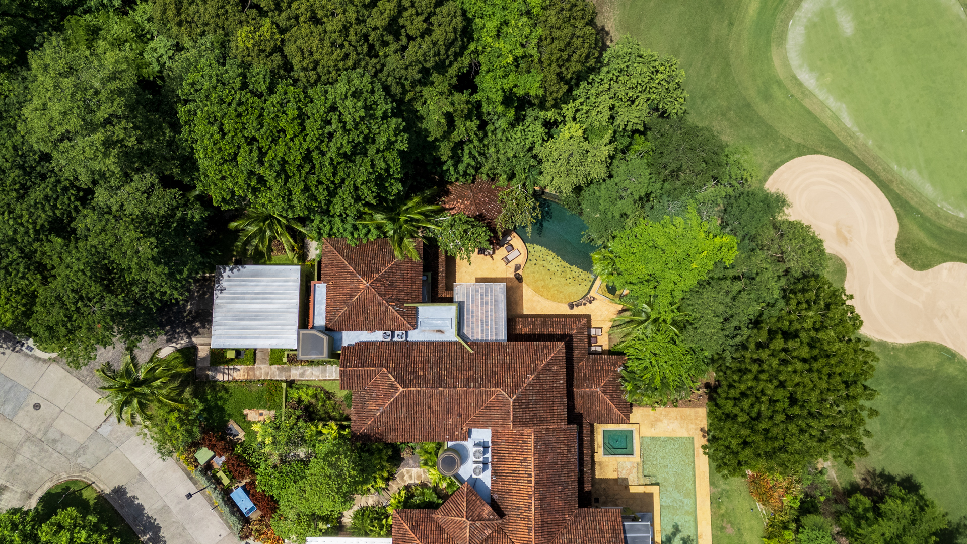 Aerial view of Villa Conchal, showing off the expansive outdoor covered patio, pool, and home